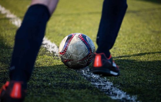 Football soccer player ready to kick the football ball, in green field on a sunny day. Premier League Predictions 2025–26
